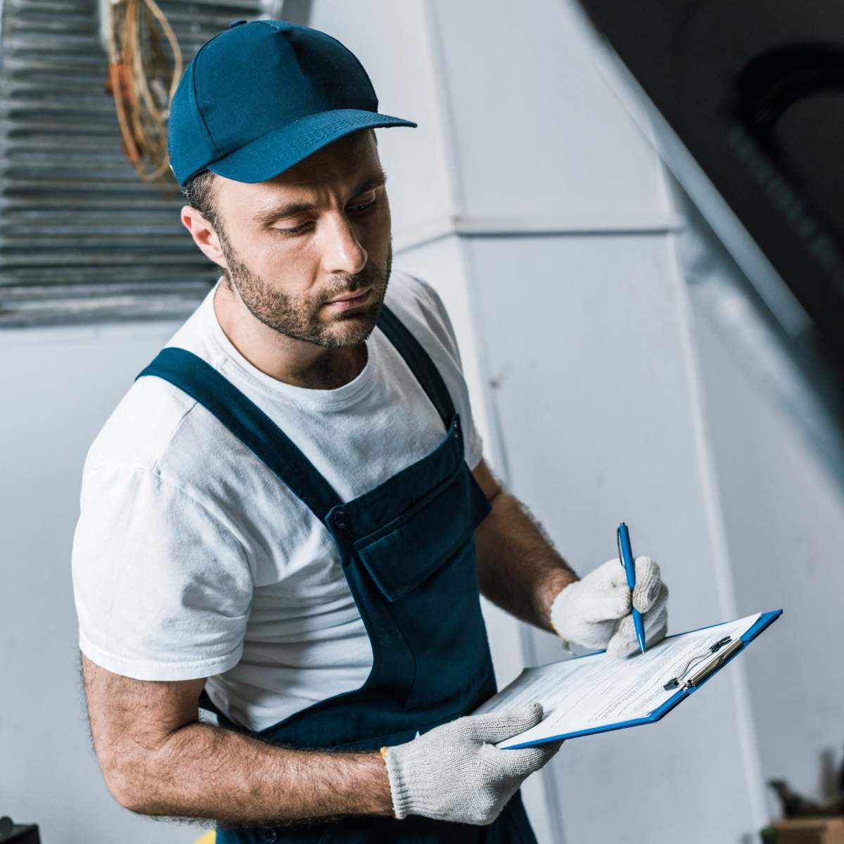 selective-focus-of-handsome-repairman-in-cap-holdi-2022-12-16-20-59-50-utc